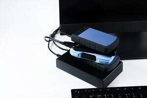 Multiple external hard drives connected to a monoblock on a white background.Computer with hard drive photo