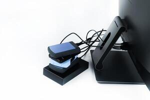 Multiple external hard drives connected to a monoblock on a white background.Computer with hard drive photo