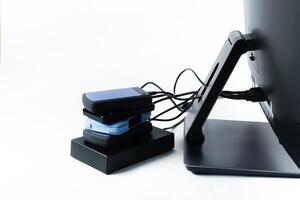 Multiple external hard drives connected to a monoblock on a white background.Computer with hard drive photo