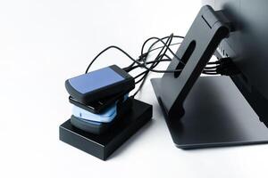 Multiple external hard drives connected to a monoblock on a white background.Computer with hard drive photo