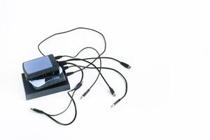 many external hard drives with wires lie on a white background. Hard drives on isolate. photo