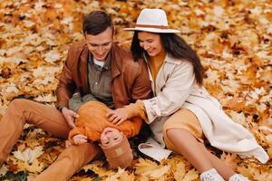 Father and mother with son walking in the autumn Park. A family walks in the Golden autumn in a nature Park. photo