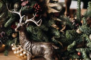 Christmas table decoration, Banquet table with glasses before serving food, Close-up of Christmas dinner table with seasonal decorations, crystal glasses and decorative deer photo