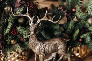 Christmas table decoration, Banquet table with glasses before serving food, Close-up of Christmas dinner table with seasonal decorations, crystal glasses and decorative deer photo