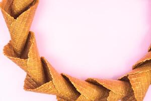 smooth circle of waffle cones for ice cream on a pink background photo