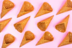 Waffle empty ice cream cones on a colored pink background photo