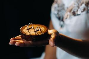 Close-up of two gold wedding rings for the wedding lie on the hand photo