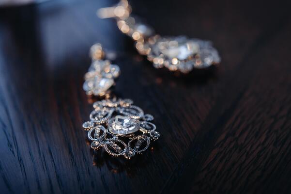 Accessories for the bride. Earrings on the veil. White wedding earrings. Space for text and ads.