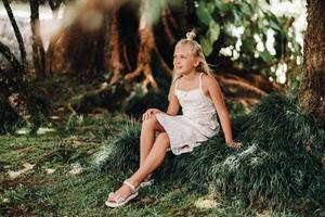 Summer portrait of a happy little girl on the island of Mauritius.beautiful smile, summer white dress. photo
