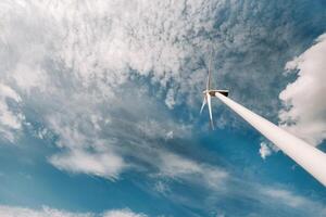 A white Windmill against a blue sky. Windmill in nature photo