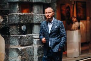 Bearded man in a suit in the old city of Lyon, stylish man in a suit in France photo