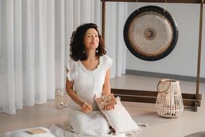 A woman in white clothes holds an envelope with a wish in her hands. The concept of a women's circle photo