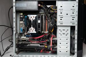 The system unit of the computer is disassembled without a cover.Lots of old computer parts. computer from the inside photo