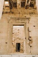 Ancient Greek ruins of Propylaea on a top of Acropolis hill in Athens. Acropolis - main tourist attraction of Athens. Greece. photo