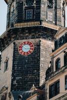 Dresden, the red great clock of the Dresden castle tower, the residence of the old kings in the city center, the Baroque Museum complex, illuminated by the sun photo