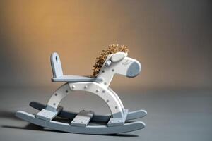 Handmade rocking horse on a gray background photo