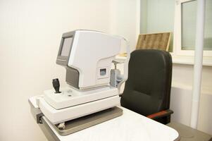The device for checking the vision of a person is in the office of an optometrist photo