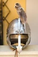 An ancient knight's helmet with a feather .Medieval concept photo