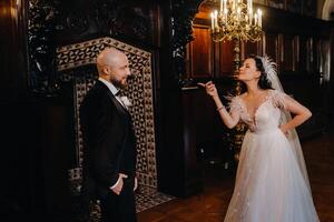 Elegant wedding couple in the interior of the old castle in the city of Nesvizh photo