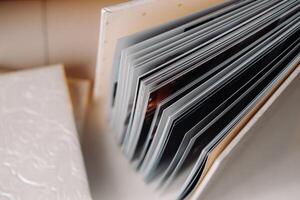 Composition of photo books in genuine white leather . Fragment of a photobook binding