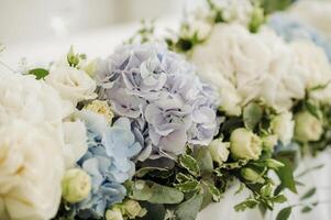 wedding table decoration with blue flowers on the table in the restaurant table decor for dinner at the wedding. photo