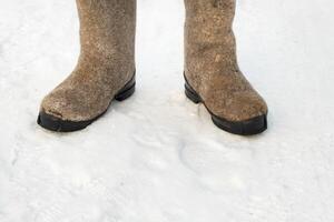 close up of felt boots standing in the snow photo