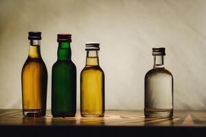 different alcohol bottles are on the table on a light background photo