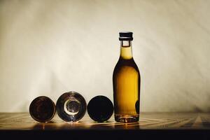 different alcohol bottles are on the table on a light background photo