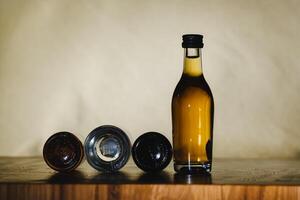 different alcohol bottles are on the table on a light background photo