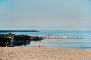 Nida - Curonian Spit and Curonian Lagoon, Nida, Klaipeda, Lithuania. Nida harbour. Baltic Dunes. Unesco heritage. Nida is located on the Curonian Spit between the Curonian Lagoon and the Baltic Sea. photo