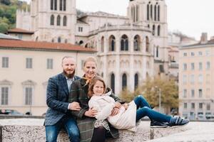 A beautiful family with strolls through the old city of Lyon in France.Family trip to the old cities of France photo