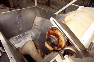 machine for making cookies in the factory. Conveyor belt with Cookie dough photo