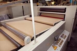machine for making cookies in the factory. Conveyor belt with Cookie dough photo
