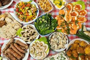 A lot of different food on the Banquet table.A large number of prepared dishes on the table.Holiday at the table photo