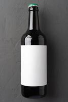 Beer bottle, on gray stone background, top view, with copy space for text photo