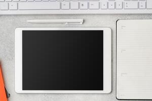Digital tablet with empty screen on table with business accessories photo