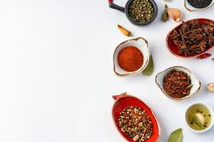 Bowls with various spices on white background photo
