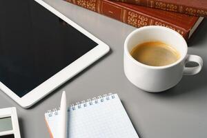 Digital tablet with empty screen on table with business accessories photo