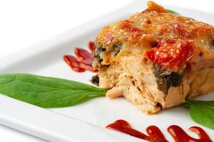 Meat with melting slice of cheese isolated on white background. photo