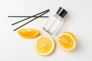 Aromatic display of essential oils with citrus fruit and chopsticks on a minimalist background photo