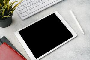 Digital tablet with empty screen on table with business accessories photo