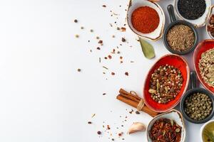 Bowls with various spices on white background photo