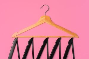 Flat lay composition with empty hangers on pink background photo