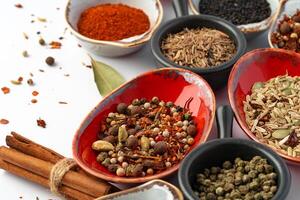 Bowls with various spices on white background photo