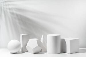A collection of white geometric shapes arranged on a table in a bright studio setting photo