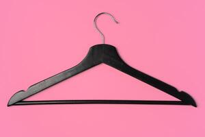 Flat lay composition with empty hangers on pink background photo
