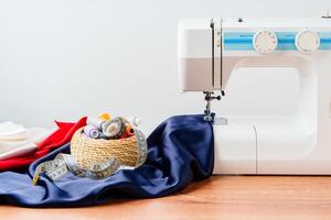 Sewing tools and materials arranged on fabric with a sewing machine in a bright workspace photo