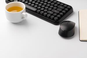 Minimalistic white workplace with keyboard and notebook photo