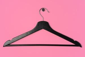 Flat lay composition with empty hangers on pink background photo