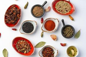 Bowls with various spices on white background photo